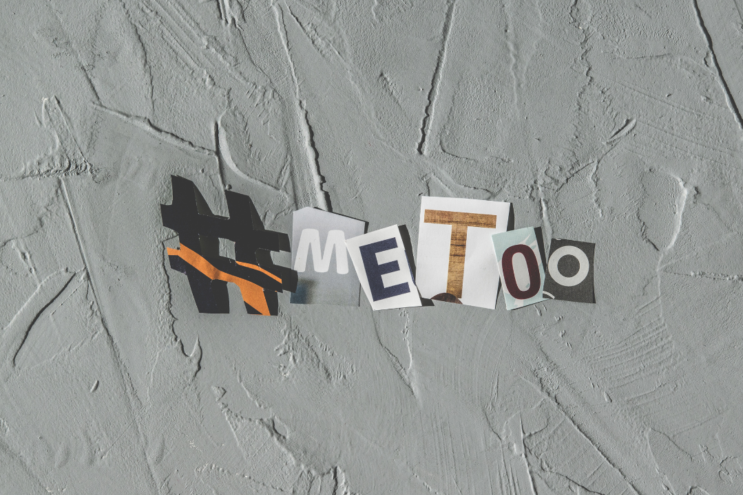 A collage-style cutout of the hashtag ‘#MeToo’ on a textured gray background, symbolizing the movement against sexual harassment and assault.